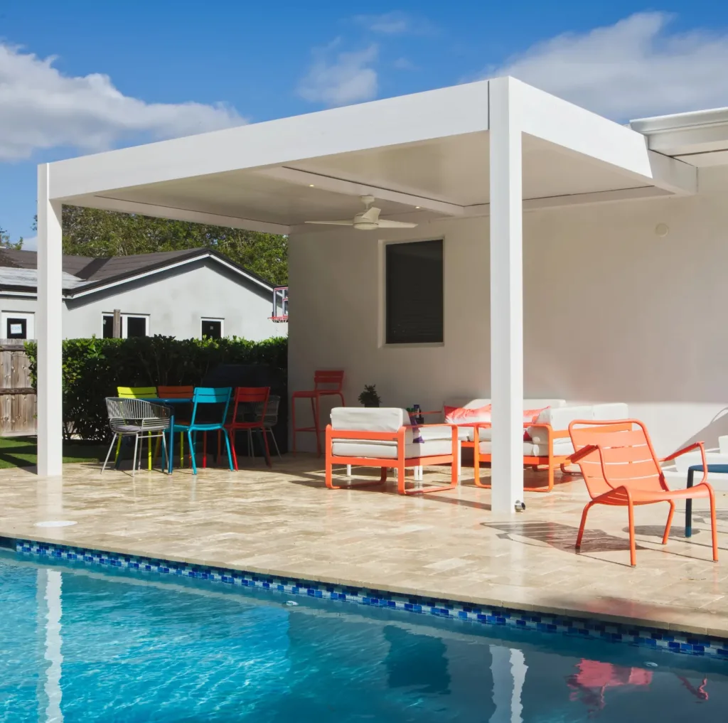 White R-SHADE insulated patio cover over an outdoor dining and lounge space