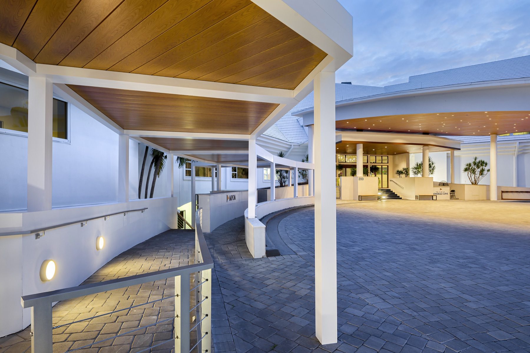 Large commercial pergola structure over a hotel outdoor lounge and pool deck