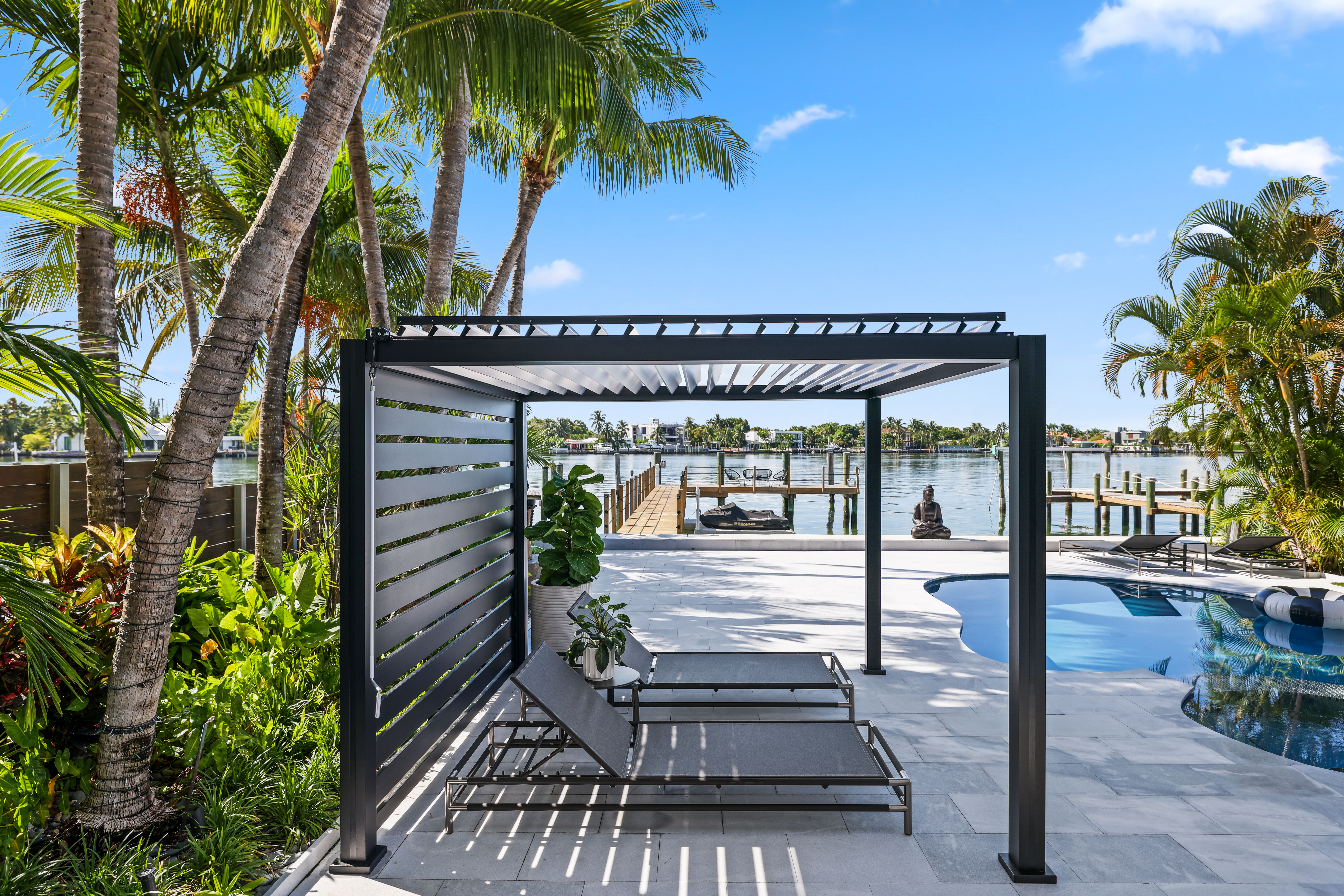 Black K-BANA with white louvers and privacy wall over pool