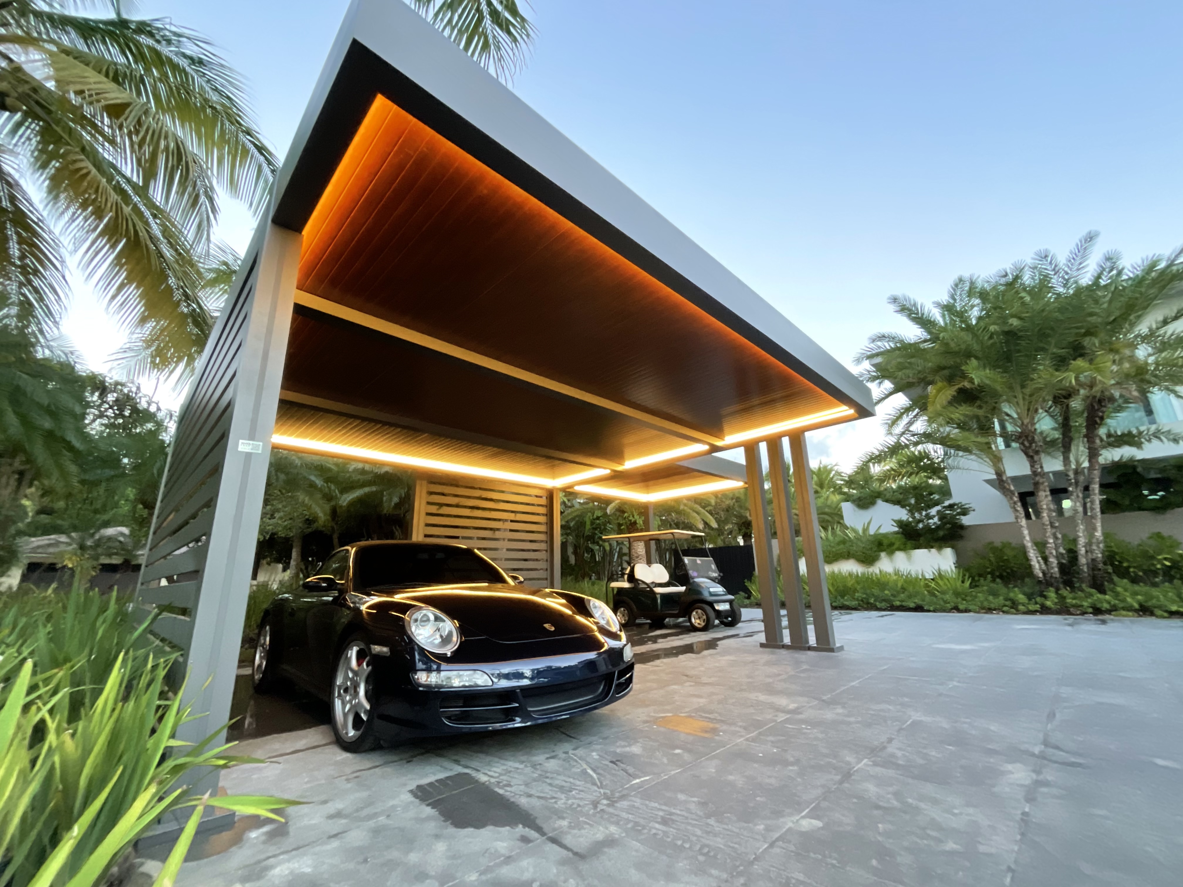 R-CAR carport with LED lighting and palm trees